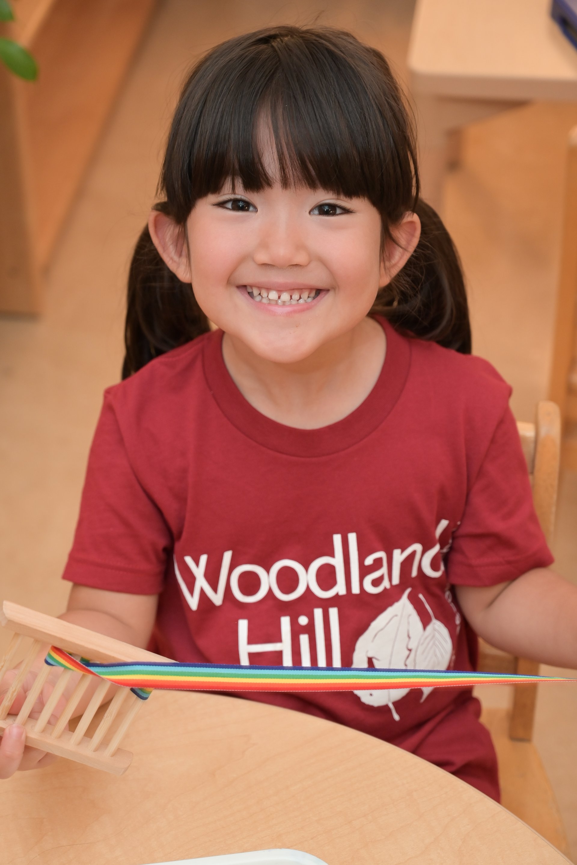 student stacking pink square blocks