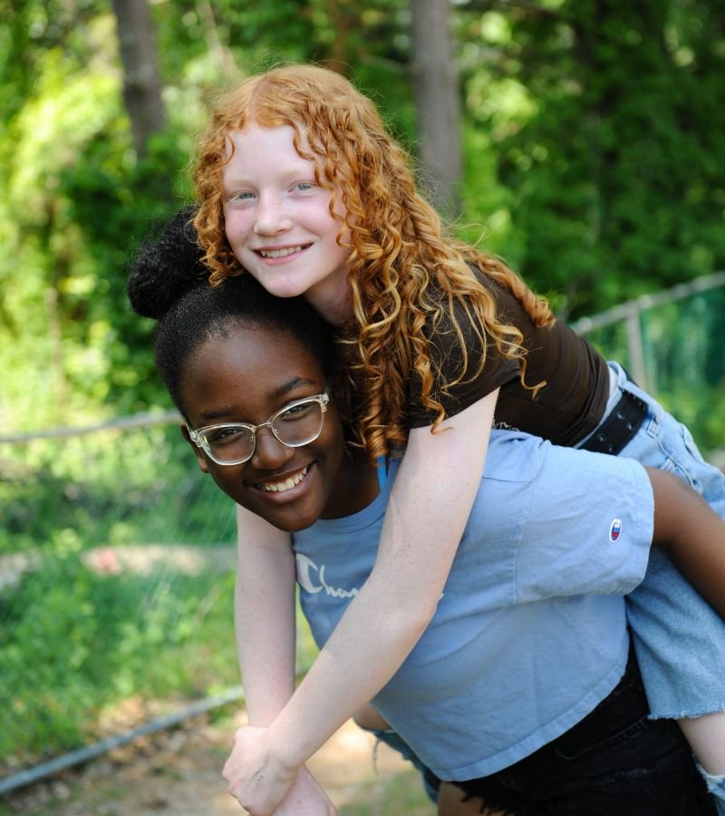 student carrying another student on their back