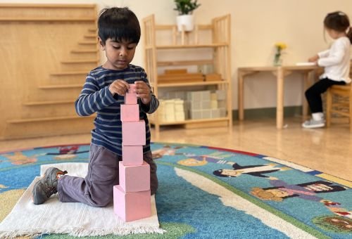 primary student stacking blocks