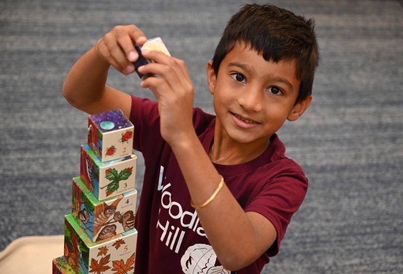 lower elementary student stacking blocks