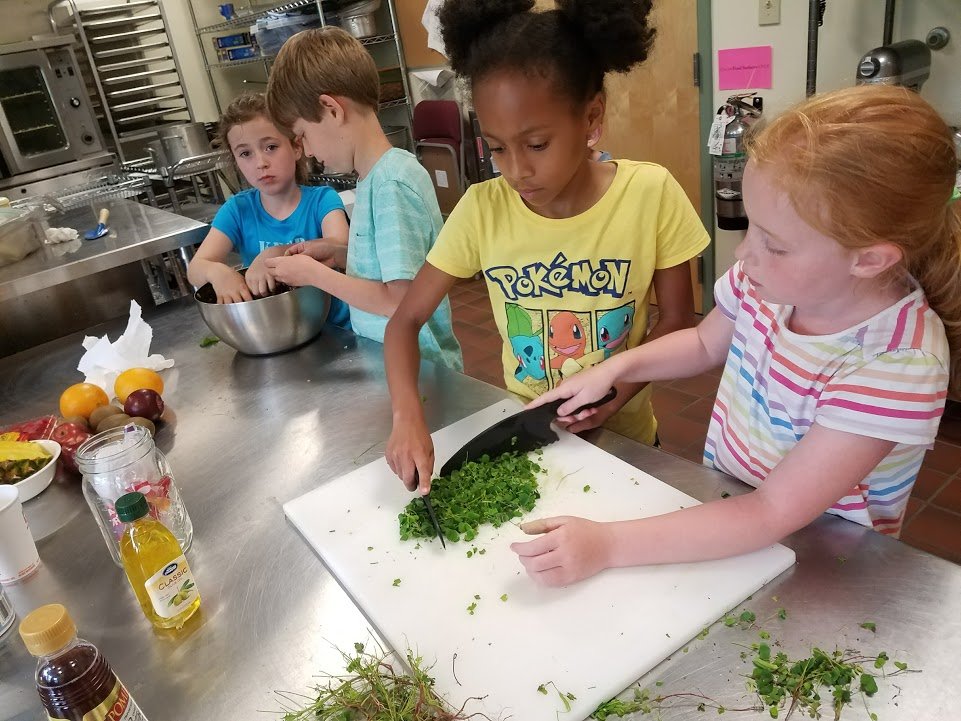 elementary campers cooking in a crock pot