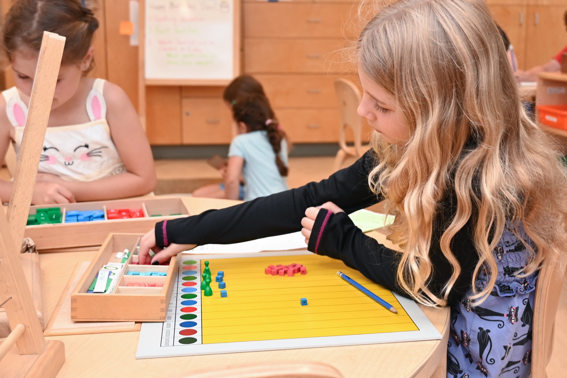 lower elementary student stacking blocks
