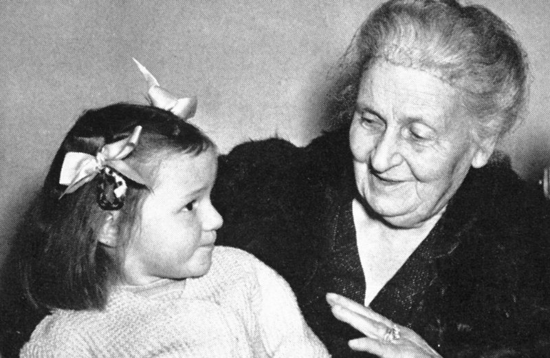 Maria Montessori talking to a young girl